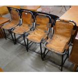 A set of four Les Arc style black metal and tan leather chairs, after Charlotte Perriand