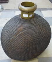 A large eastern chain wrapped brass bottle shaped vessel