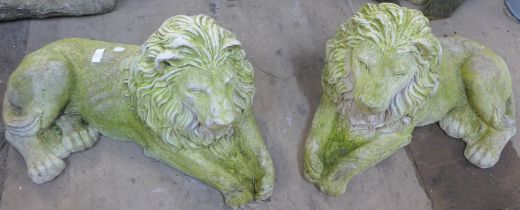 A pair of concrete garden figures of recumbent lions