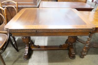 A carved oak draw-leaf table