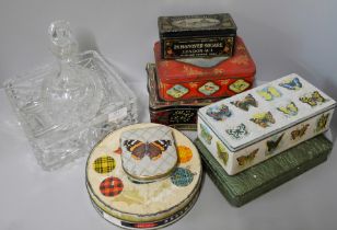 A glass decanter, fruit bowl and seven vintage tins