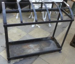 A Victorian black wrought iron strapwork stick stand