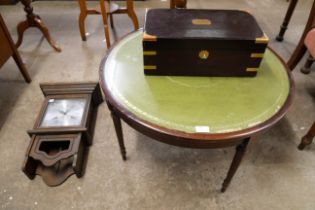 A circular coffee table, a wall clock and a Victorian box