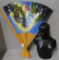 A bust of a lady and a large oriental fan