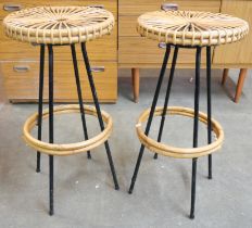 A pair of Italian style black metal and bamboo bar stools