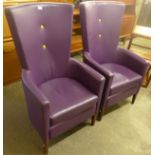 A pair of beech and purple leather highback armchairs