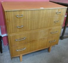 A teak chest of drawers