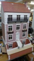 A large vintage dolls house, with furnishings and figures