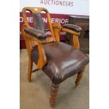 An early 20th Century beech and brown leather adjustable dentist's chair