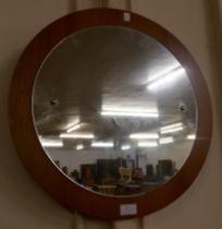 A teak circular framed mirror