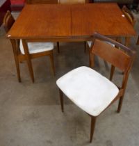 A teak extending dining table and four chairs