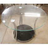 A circular glass and chrome coffee table