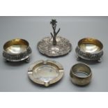 A silver Reynolds Angels ring stand, Birmingham 1907, a silver ashtray, a silver napkin ring and a