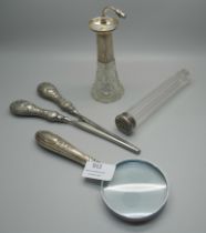A pair of silver handled glove stretchers, silver handled magnifying glass, a silver topped glass