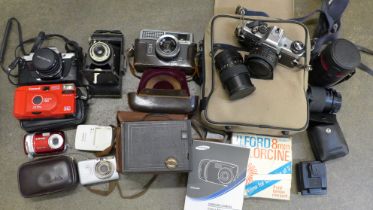 Cameras; Praktica BCX with lenses and bag, Olympus OM10 with two lenses and flash unit, a Minolta