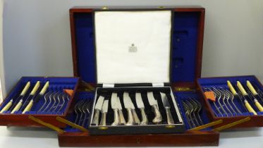 A set of silver plated handled knives and a wooden canteen of cutlery