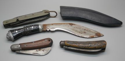 A military issue knife, two other knives and a small kukri