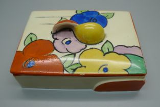 A Clarice Cliff Fantasque lidded pot, 11.5cm wide, star crack to the lid