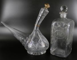 An oversized spirit decanter engraved with flowers and foliage, and a sangrilla carafe