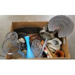 A box of assorted items, Indian brass peacock, charger, studio pottery, travel clocks, treen, a