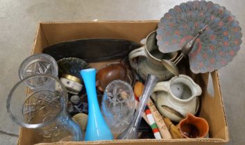 A box of assorted items, Indian brass peacock, charger, studio pottery, travel clocks, treen, a