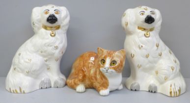 A pair of Beswick Staffordshire spaniels and a Mike Hinton model of a cat, very small glaze chip