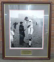 Football, a scarce silver gelatin 370 x 430 photograph of Duncan Edwards signing an autograph, 1st