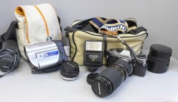 An Olympus OM10 camera body with lens and a Sony Handycam, etc.