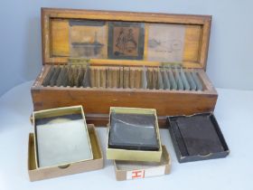 A wooden case of lantern slides and three boxes of lantern slides