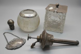 A silver rimmed match striker, a silver topped cut crystal pot, a silver sherry label, a silver