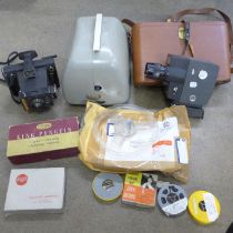 A collection of camera and film equipment including a Hanimex projector, a folding camera, a
