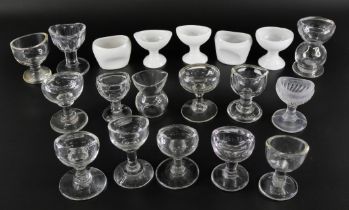 A collection of clear glass eye baths and ceramic eye baths (19)