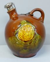 A Royal Doulton treacle glaze flask with silver topped stopper, decorated with Jolly Sailor and