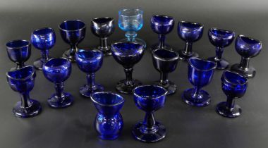 Eighteen blue glass eye baths, some hand blown