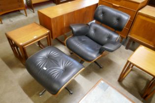 A Charles & Ray Eames style rosewood effect and black leather revolving lounge chair and ottoman