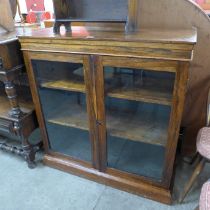 A Regency rosewood, mahogany and stained pine two door bookcase
