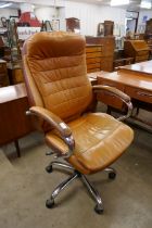 A tan leather and chrome revolving desk chair