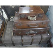 A travel trunk and three suitcases