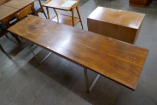 A long chrome and walnut dining table