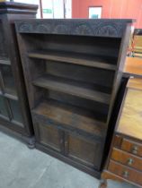 An early 20th Century Jacobean Revival carved oak open bookcase
