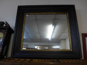 A large gilt and ebonised framed mirror