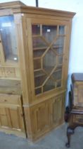 A George III style pine freestanding corner cabinet