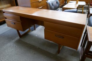 A teak desk and chair