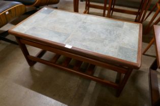 A Scandinavian teak and tiled top coffee table