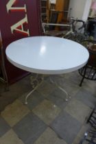 A white circular garden table