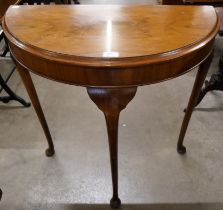 A walnut demi-lune hall table