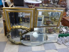 A collection of assorted mirrors and a print