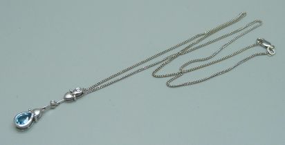 An 18ct white gold pendant on an 18ct white gold chain, set with a blue stone and diamond, 5g, chain