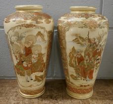 A pair of Japanese Meili period Satsuma vases decorated in enamels and gilt, painted all over with