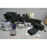 A Kodak folding camera, model H, other cameras including Canon, a light meter, a Canon camcorder and